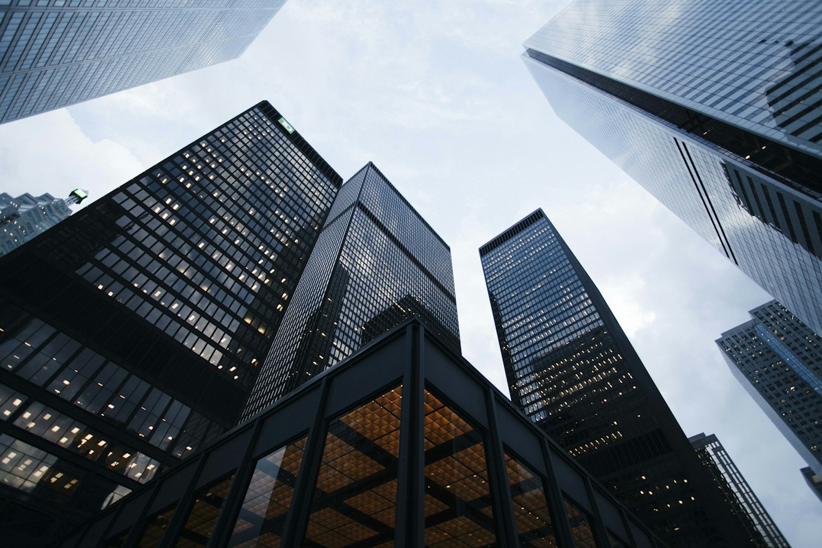 Modern office towers reaching into a bright sky